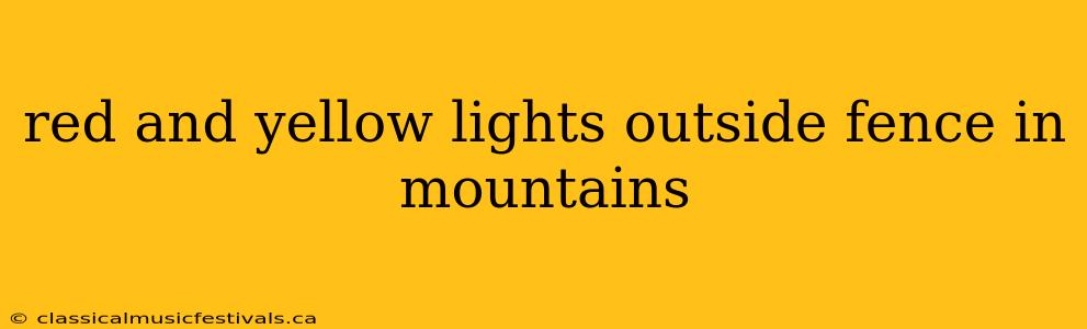 red and yellow lights outside fence in mountains